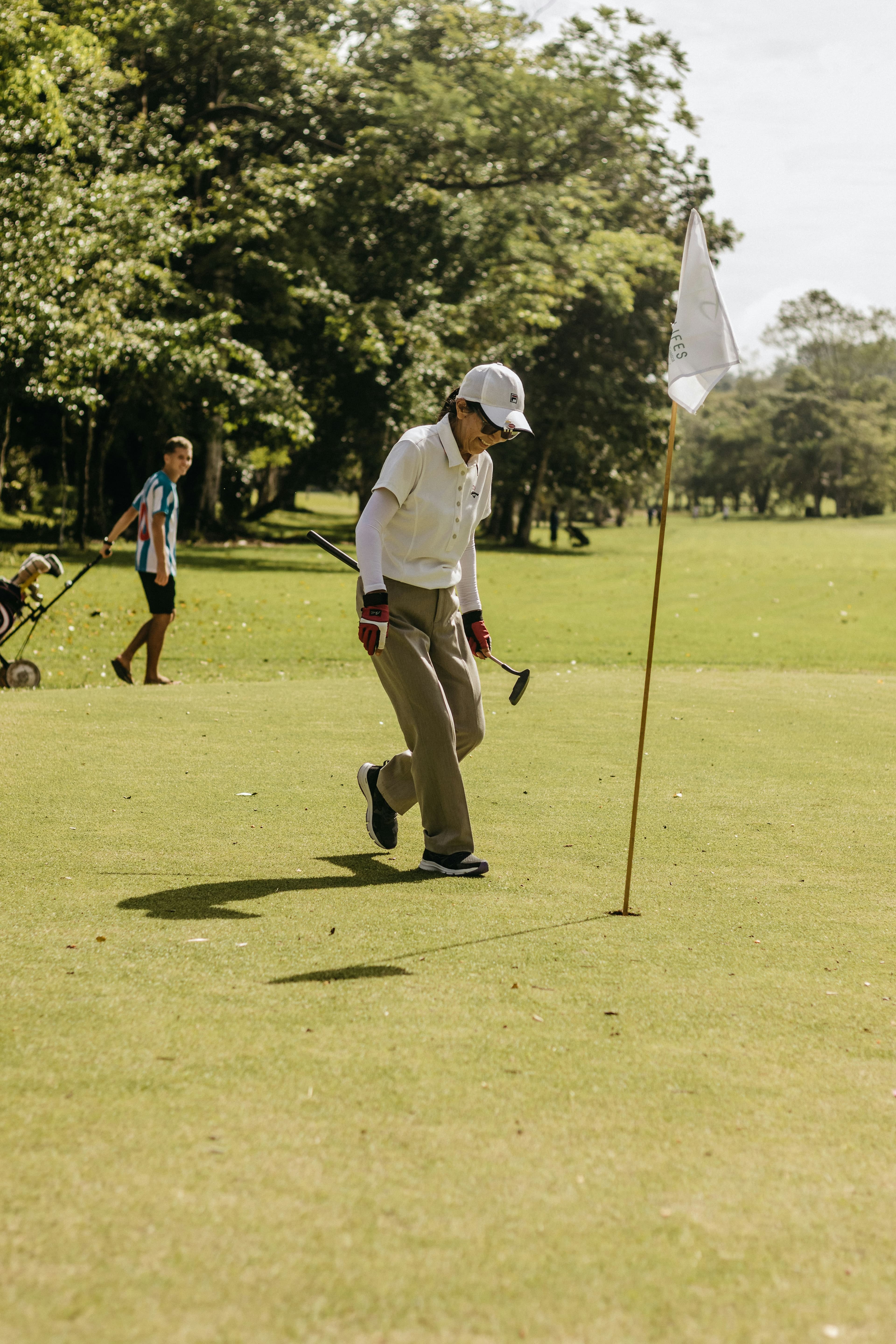 Golfer celebrating beside the hole on a green